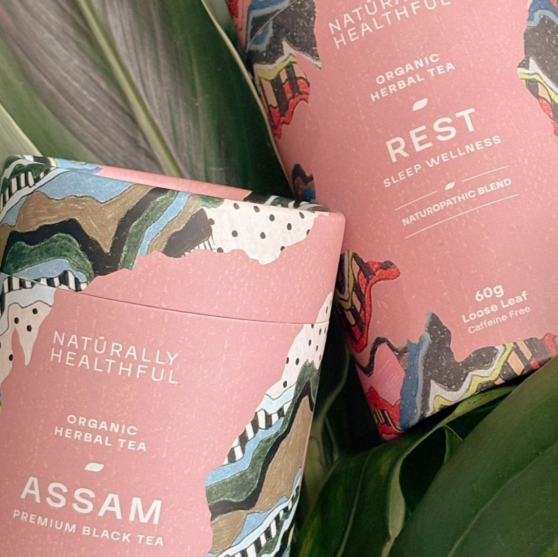 Rest and Assam tea cylinders resting on green leaf