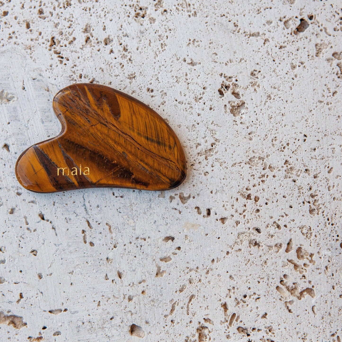 Gua sha tool for face made from Tiger Eye crystal