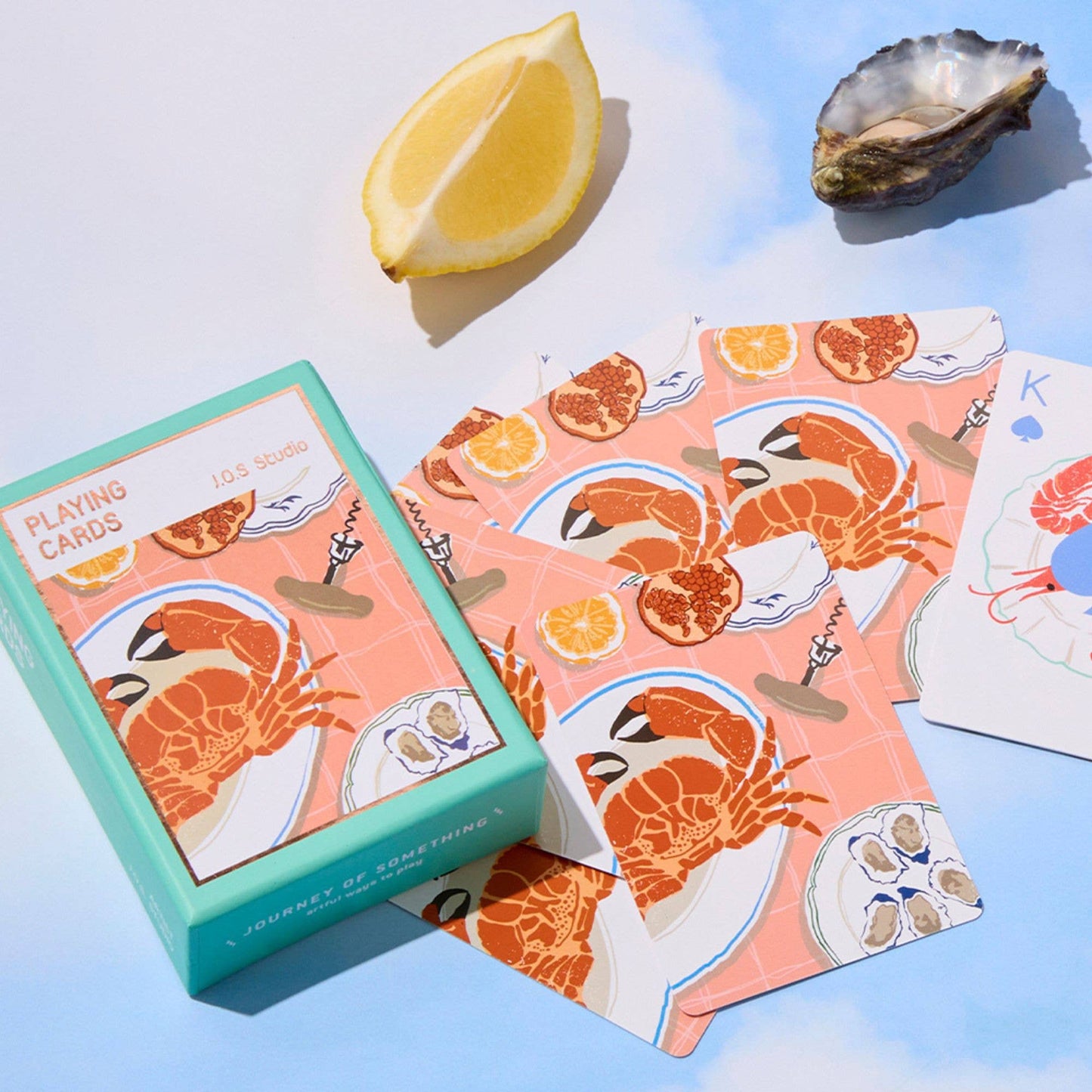 Playing cards with seafood design on a light blue background