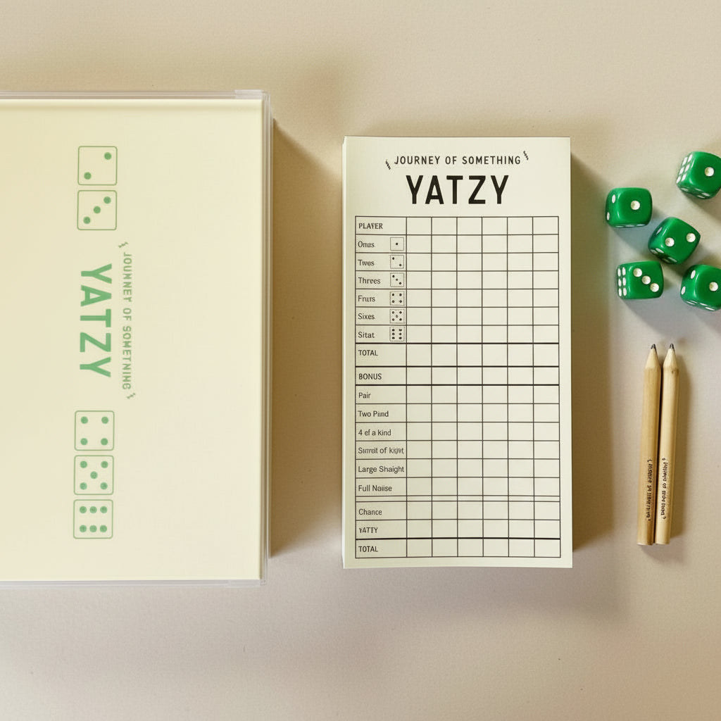 Yatzy game set with dice and scorecard on a white background